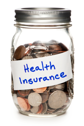 Jar of Coins Labeled Health Insurance on White